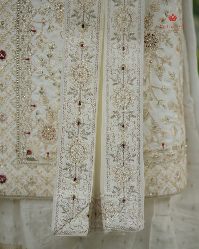 Embroidered dupatta with intricate patterns and red stones on a white background