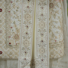 Embroidered dupatta with intricate patterns and red stones on a white background