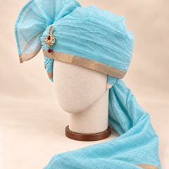 Left side view of aqua gold border premium barati safa showing the smooth wrap and long bordered tail