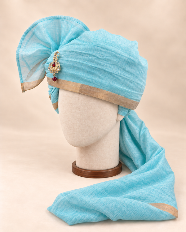 Left side view of aqua gold border premium barati safa showing the smooth wrap and long bordered tail