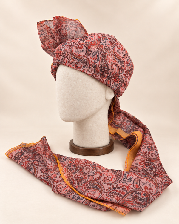 Left side view of blush pink paisley Barati Safa showing the smooth wrap and mustard-edged tail