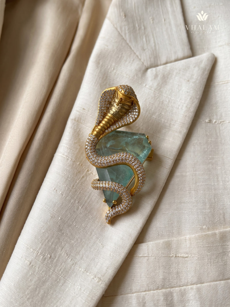 Gold-Tone Cobra Brooch with Pastel Green Accent, styled detail view