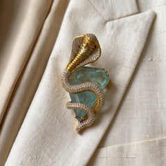 Gold-Tone Cobra Brooch with Pastel Green Accent, styled detail view