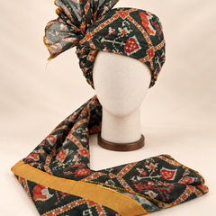 Front view of dark green geometric print Barati Safa with cream orange stepped diamond lattice