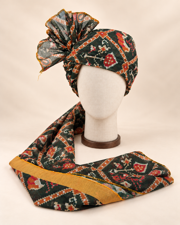 Front view of dark green geometric print Barati Safa with cream orange stepped diamond lattice