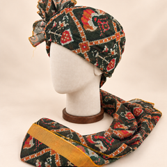 Left side view of dark green geometric print Barati Safa with red ochre motifs and broad mustard edge
