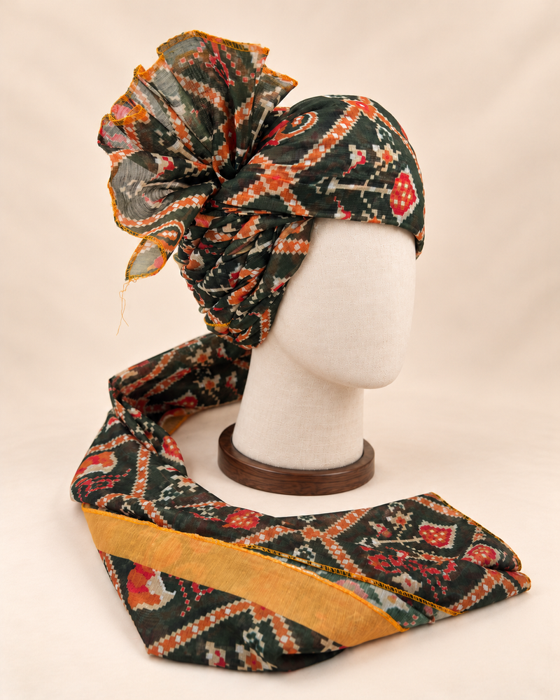 Right side view of dark green geometric print Barati Safa showing twisted folds and fan