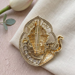 Devotional Face Brooch with Trident Motif, rear view
