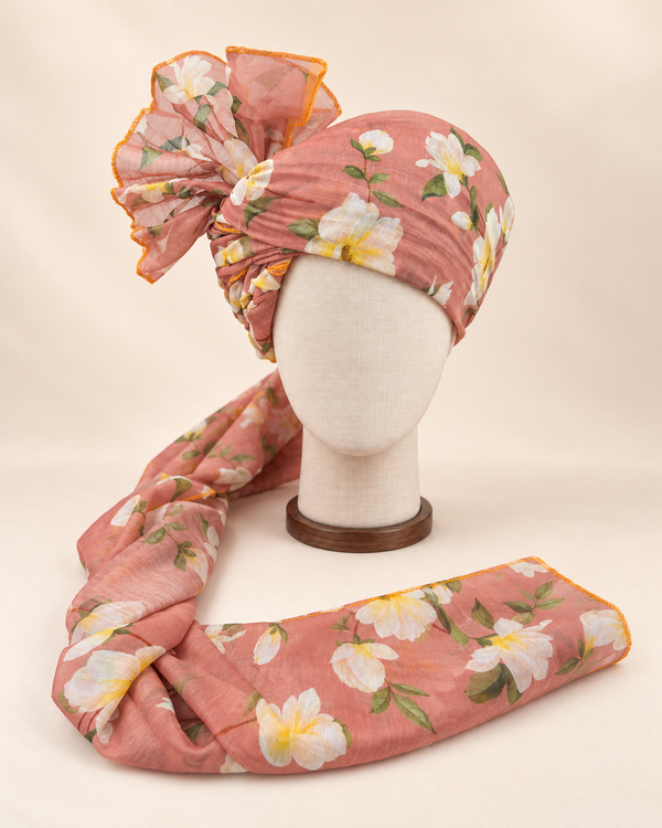 Front view of dusty peach white floral print barati safa showing the patterned wrap and fan