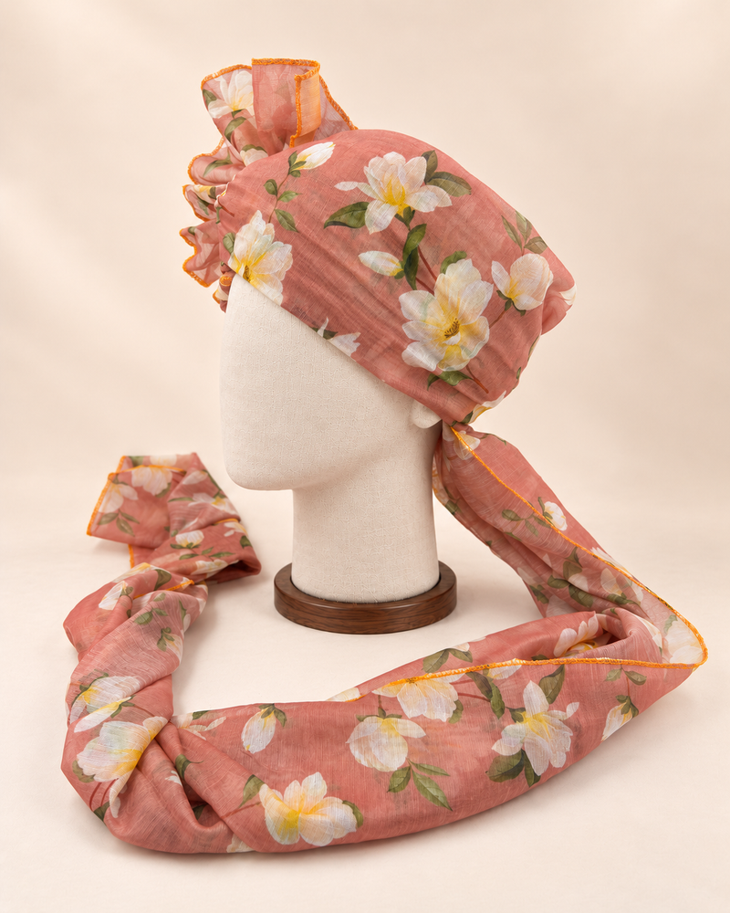 Left side view of dusty peach white floral print barati safa showing the smooth wrap and long patterned tail