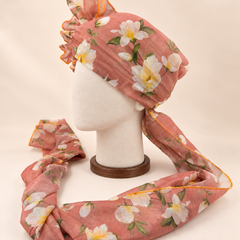 Left side view of dusty peach white floral print barati safa showing the smooth wrap and long patterned tail