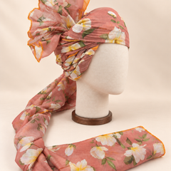 Right side view of dusty peach white floral print barati safa showing twisted folds and fan detail