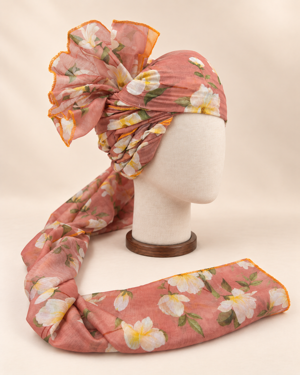 Right side view of dusty peach white floral print barati safa showing twisted folds and fan detail