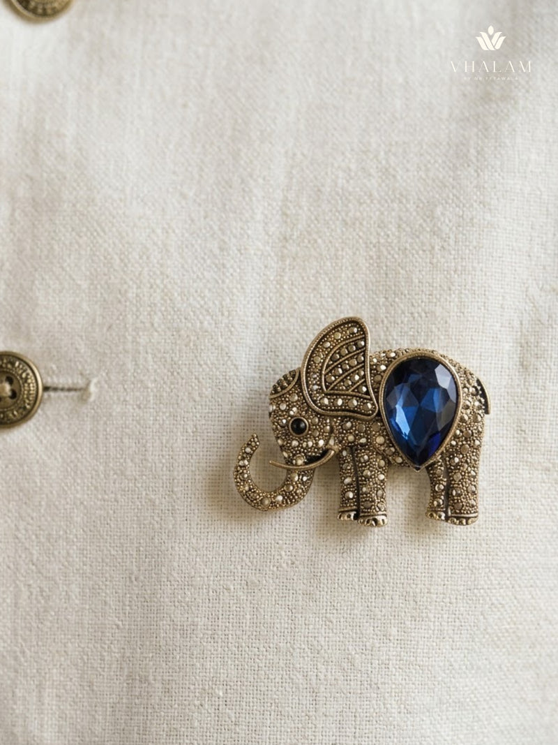 Gold-Tone Blue Elephant Brooch, styled detail view