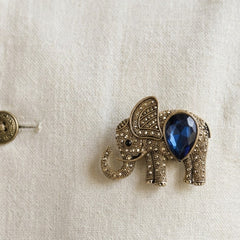 Gold-Tone Blue Elephant Brooch, styled detail view