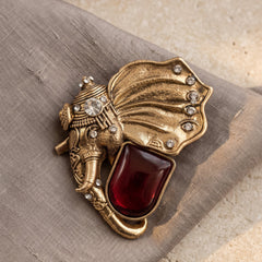 Gold-Tone Elephant Head Brooch with Red Accent, front view