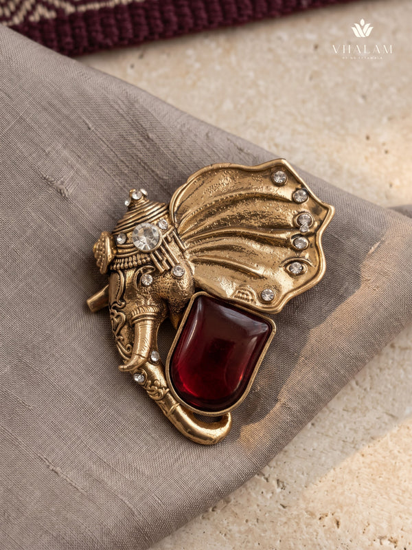 Gold-Tone Elephant Head Brooch with Red Accent, front view