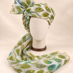 Front view of ivory green leaf print barati safa showing the patterned wrap and fan