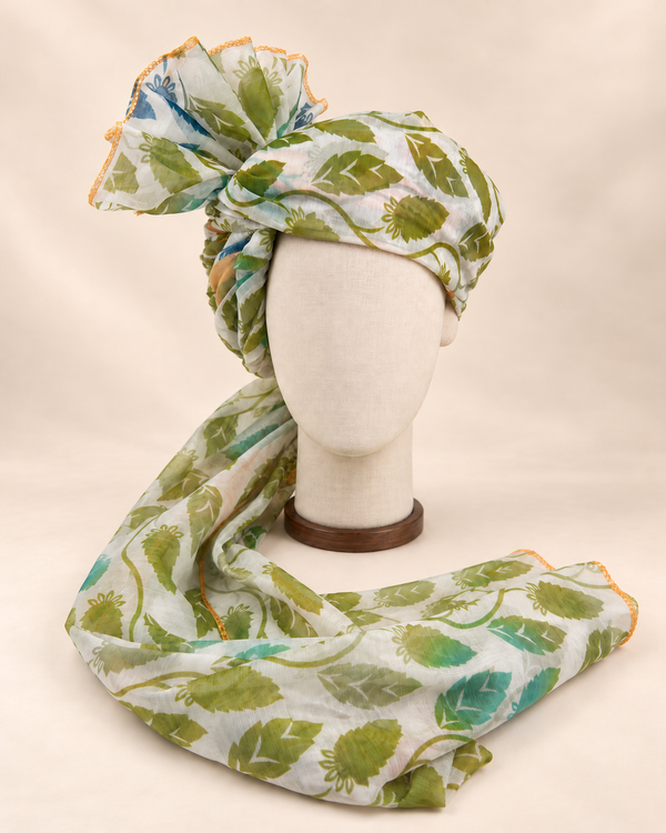 Front view of ivory green leaf print barati safa showing the patterned wrap and fan