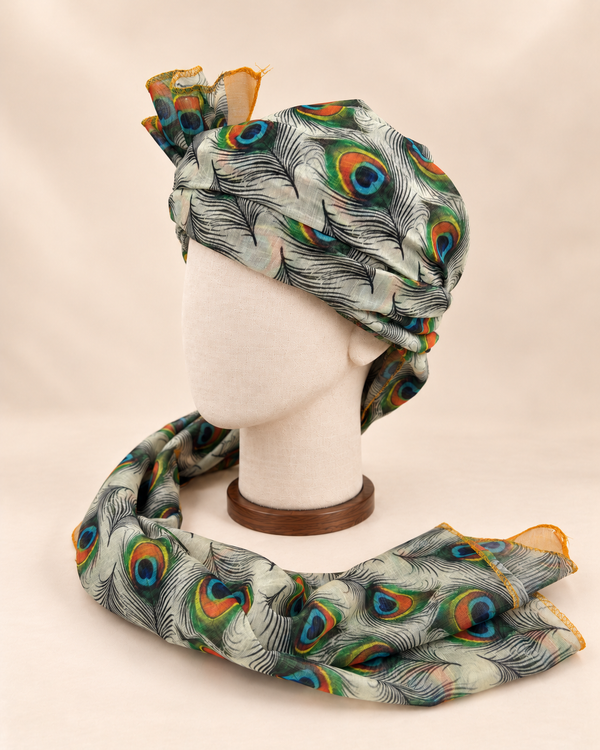 Left side view of ivory peacock feather print Barati Safa showing its wrap and patterned tail