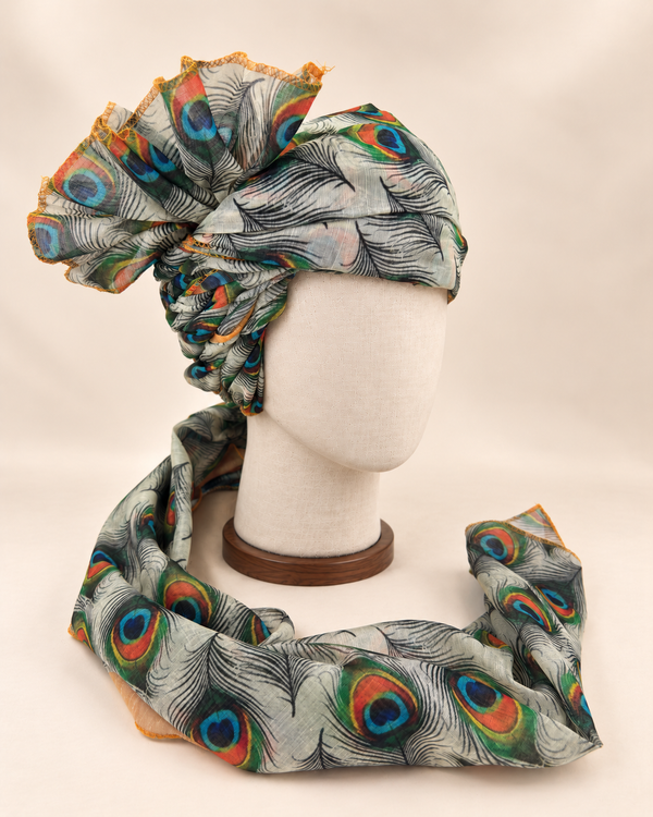 Right side view of ivory peacock feather print Barati Safa showing twisted folds and fan