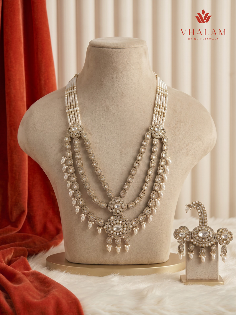Ivory pearl and floral moissanite dulha mala on a cream display bust