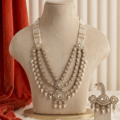 Ivory pearl and floral moissanite dulha mala on a cream display bust