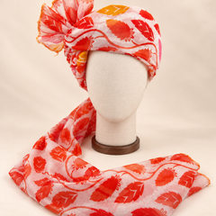 Front view of ivory red leaf print barati safa showing the patterned wrap and fan
