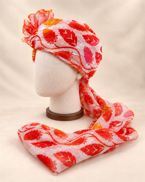 Left side view of ivory red leaf print barati safa showing the smooth wrap and long patterned tail