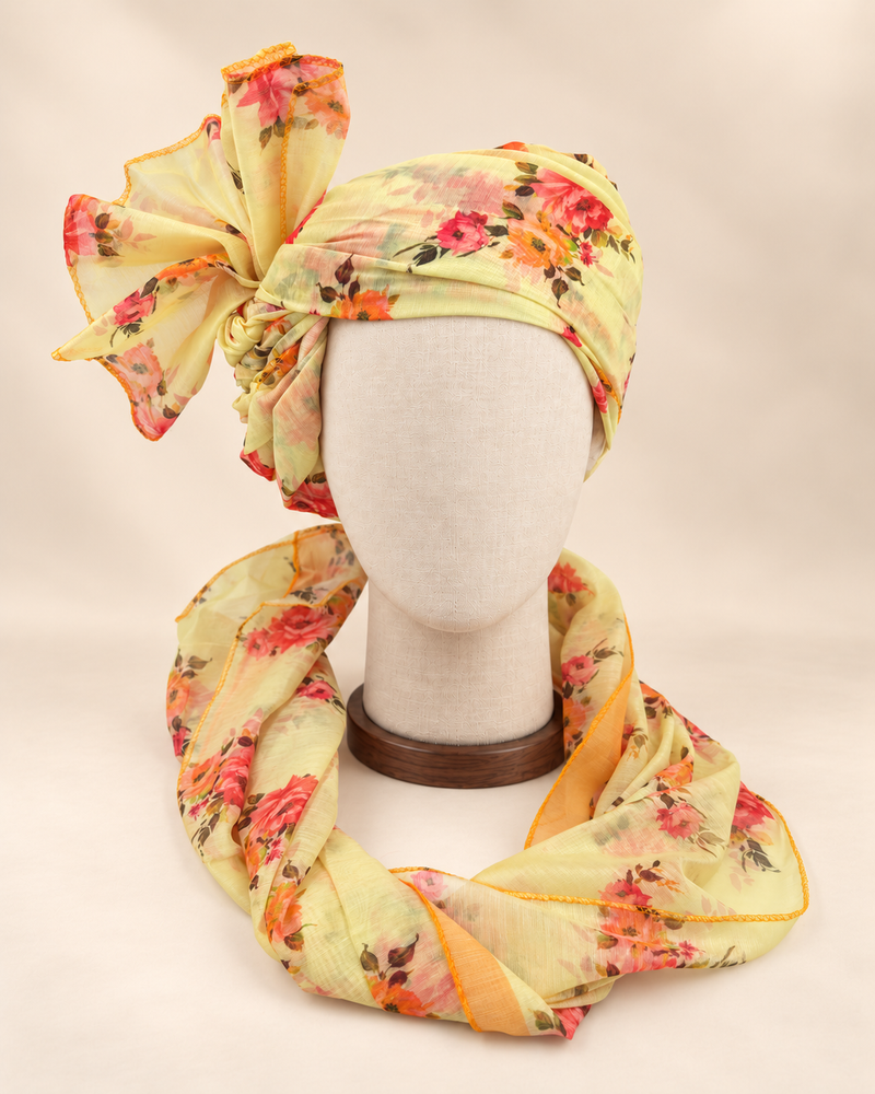 Front view of lemon yellow floral Barati Safa with coral orange bouquets and olive leaves