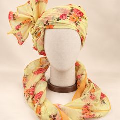 Front view of lemon yellow floral Barati Safa with coral orange bouquets and olive leaves