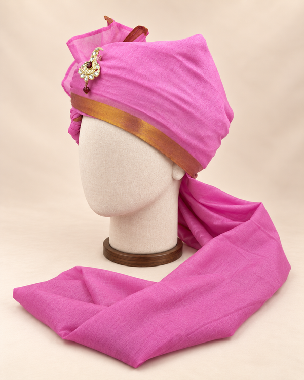 Left side view of magenta gold border premium barati safa showing the smooth wrap and long bordered tail