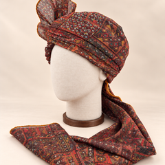 Left side view of maroon and charcoal geometric Barati Safa showing its wrap and ochre edge stitching