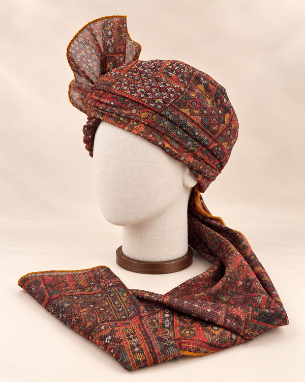 Left side view of maroon and charcoal geometric Barati Safa showing its wrap and ochre edge stitching