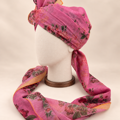 Left side view of mauve rose floral print barati safa showing the smooth wrap and long patterned tail
