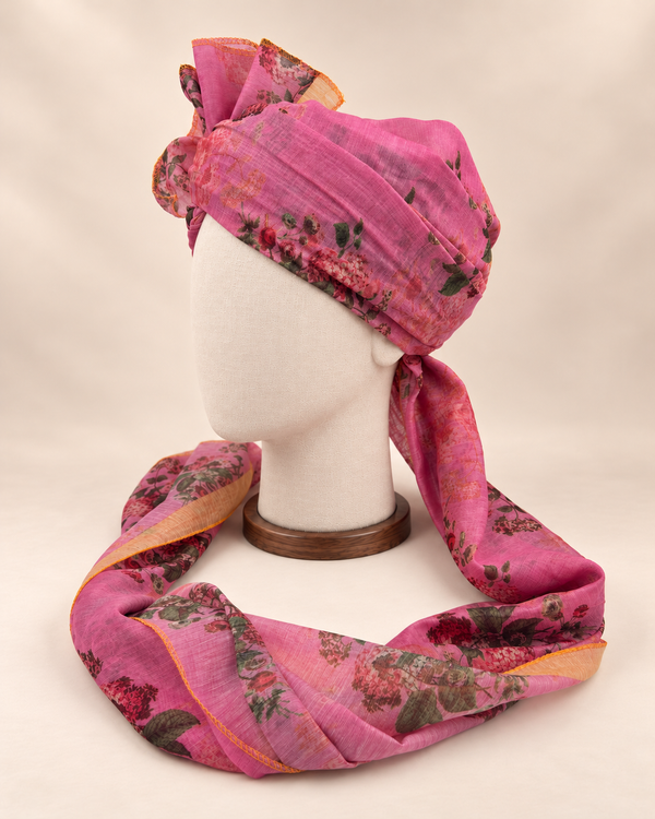 Left side view of mauve rose floral print barati safa showing the smooth wrap and long patterned tail