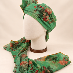 Left side view of mint green rose floral print barati safa showing the smooth wrap and long patterned tail
