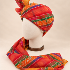 Left side view of multicolour banded bandhani print barati safa showing the smooth wrap and long patterned tail