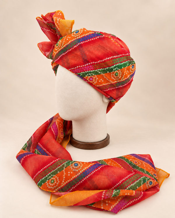 Left side view of multicolour banded bandhani print barati safa showing the smooth wrap and long patterned tail