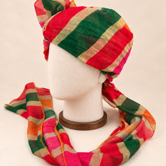 Left side view of multicolour bold stripe barati safa showing the smooth wrap and long patterned tail
