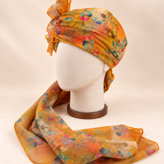 Left side view of mustard multicolour floral print barati safa showing the smooth wrap and long patterned tail