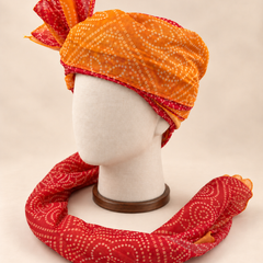 Left side view of mustard rust bandhani print Barati Safa showing the dotted paisley wrap and long patterned tail
