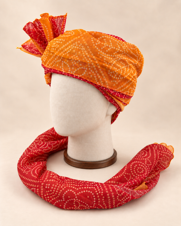 Left side view of mustard rust bandhani print Barati Safa showing the dotted paisley wrap and long patterned tail