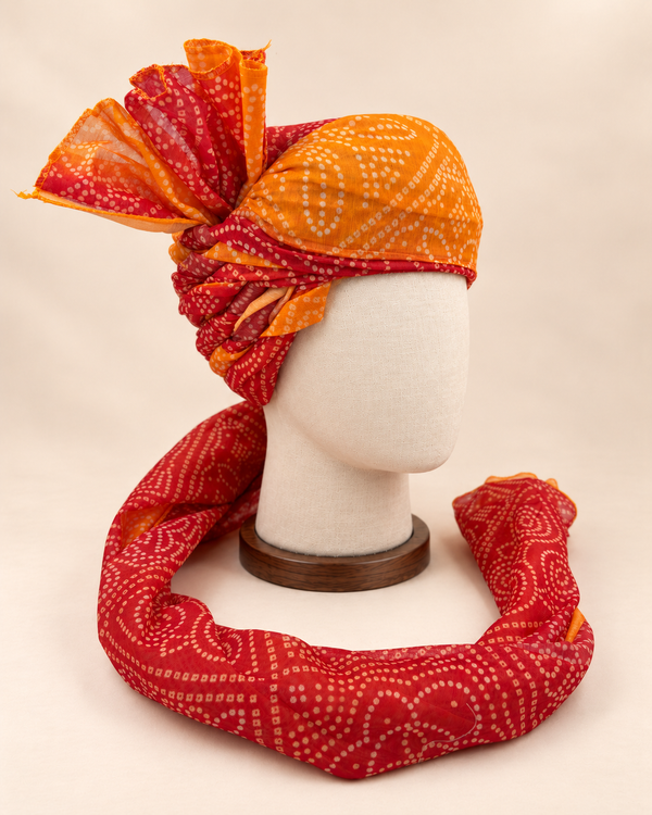 Right side view of mustard rust bandhani print Barati Safa showing twisted folds and cream dotted fan