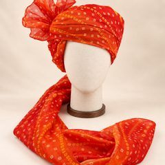 Front view of orange gold dot bandhani print barati safa showing the patterned wrap and fan