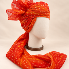 Right side view of orange gold dot bandhani print barati safa showing twisted folds and fan detail