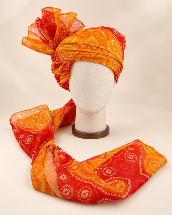 Front view of orange paisley bandhani print barati safa showing the patterned wrap and fan