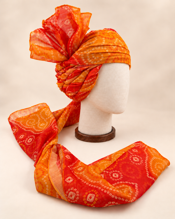 Right side view of orange paisley bandhani print barati safa showing twisted folds and fan detail
