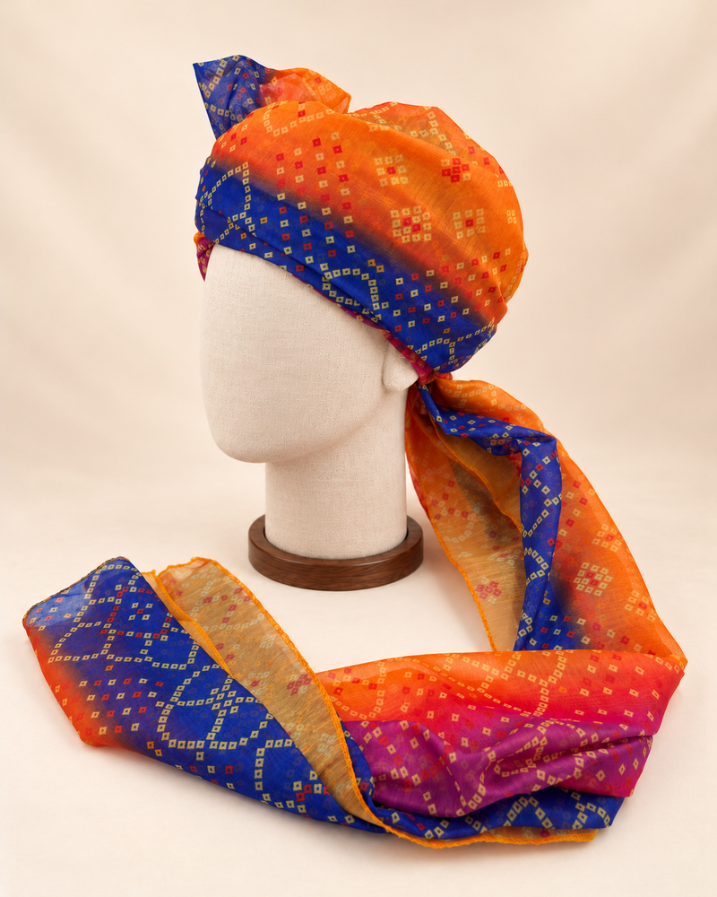 Left side view of orange royal blue multicolour bandhani Barati Safa showing its wrap and patterned tail