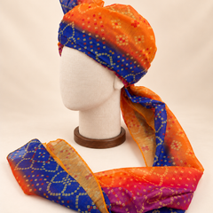 Left side view of orange royal blue multicolour bandhani Barati Safa showing its wrap and patterned tail
